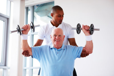 caregiver assisting senior man doing an exercise