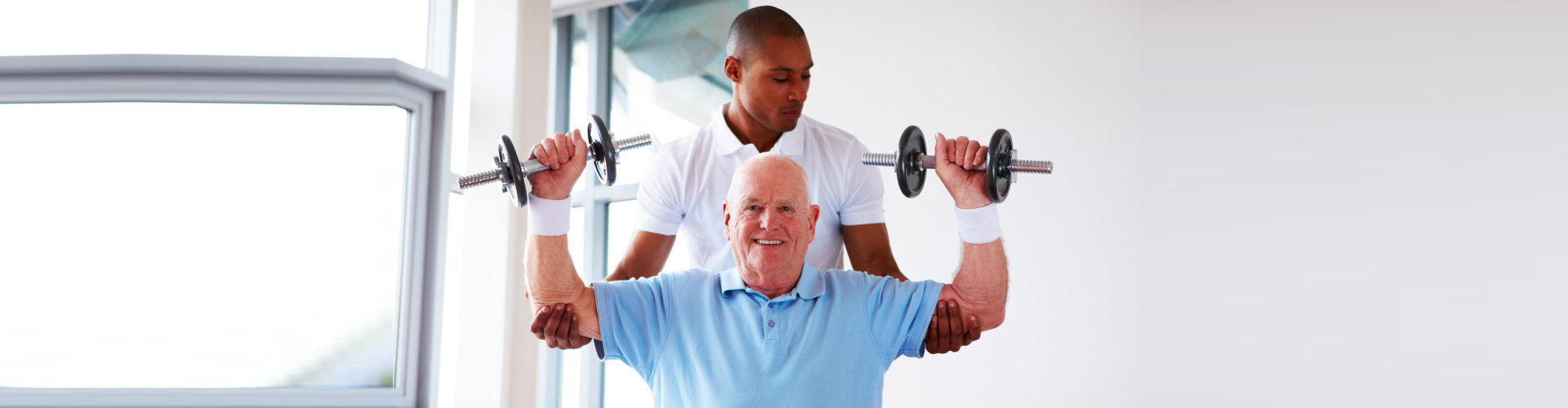 Caregiver assisting senior man doing an exercise